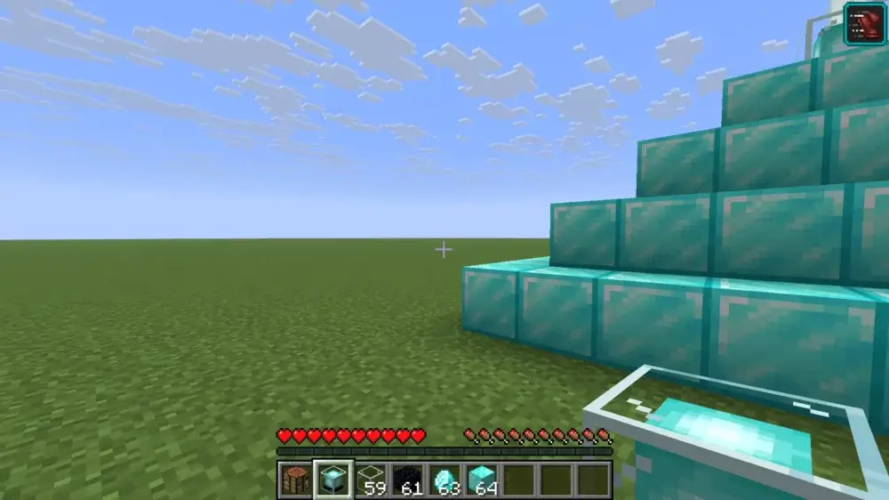 Player holding a beacon beside a diamond block pyramid in Minecraft