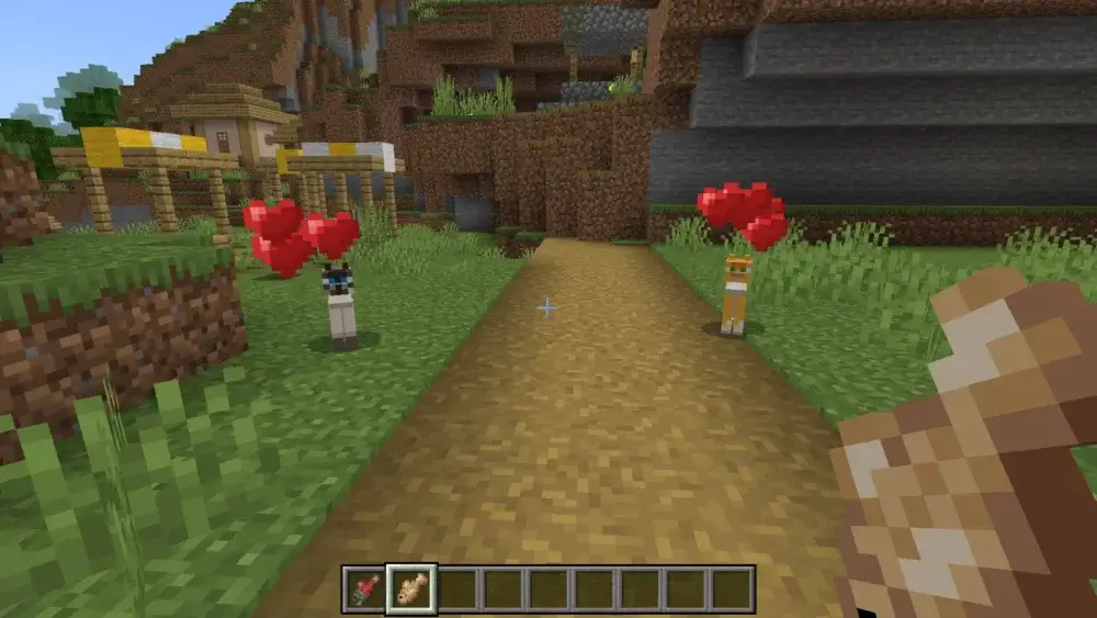 Two tamed Minecraft cats in Love Mode with hearts above them